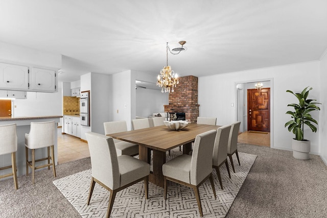 4415 Fallbrook Dr, Houston, TX 77018 - dining space with a chandelier, light colored carpet, and a brick fireplace