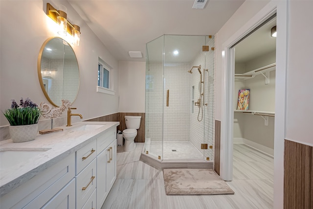 bathroom featuring a shower with door, vanity, toilet, and wood walls