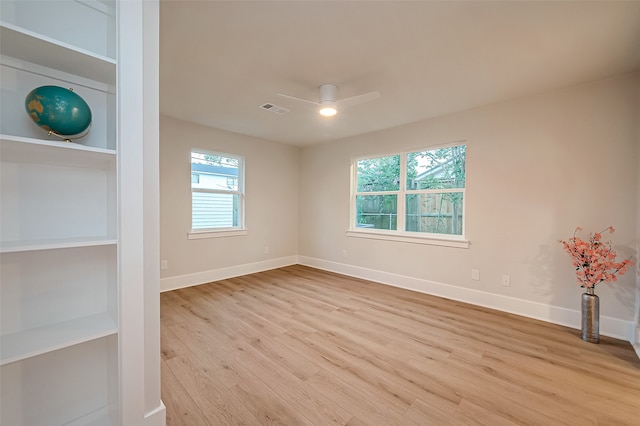 spare room featuring light wood-type flooring and ceiling fan