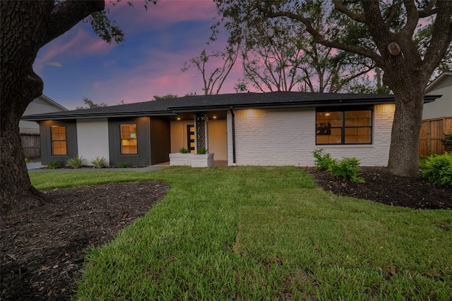 ranch-style home featuring a yard