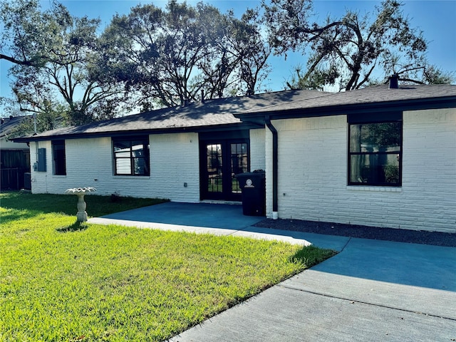 view of front of property with french doors and a front lawn