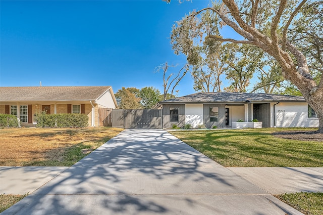 single story home featuring a garage and a front lawn