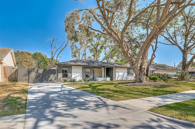 view of front of property with a front yard and a garage