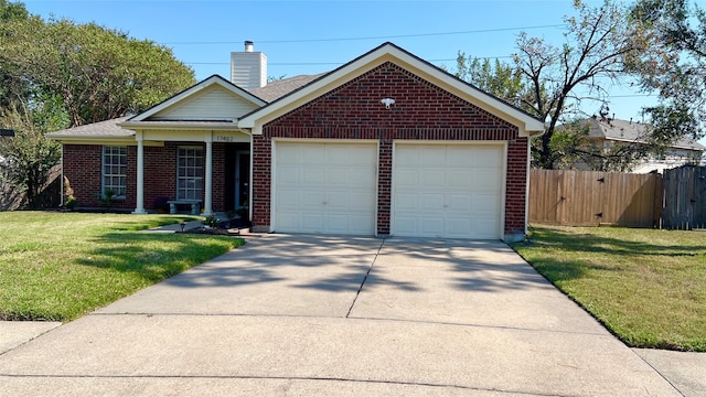 view of front of property featuring a garage and a front lawn