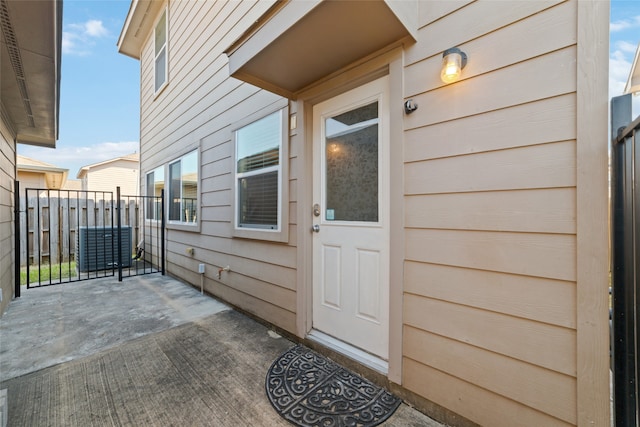 view of exterior entry with a patio