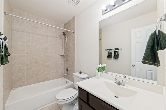 full bathroom featuring tiled shower / bath, vanity, toilet, and tile patterned floors