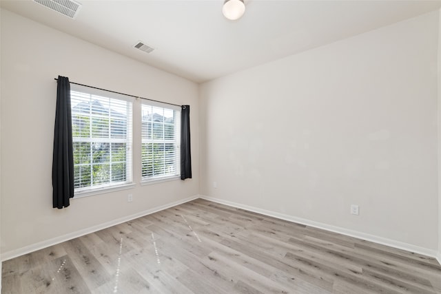 spare room with light hardwood / wood-style floors