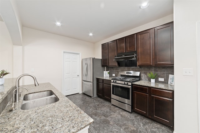 kitchen with light stone counters, decorative backsplash, exhaust hood, sink, and appliances with stainless steel finishes