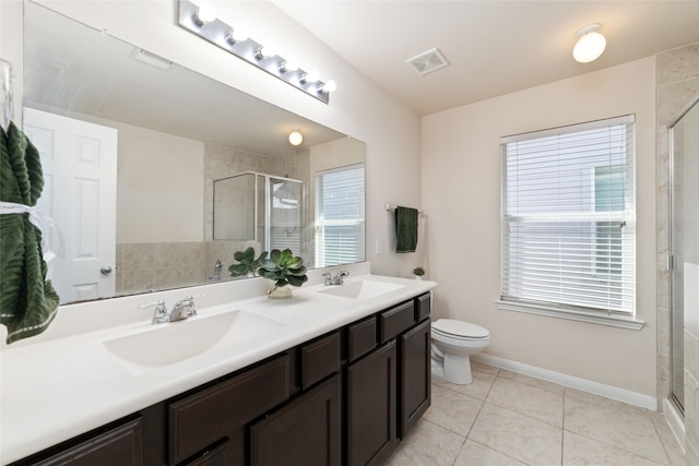 bathroom featuring vanity, a shower with shower door, toilet, and tile patterned flooring