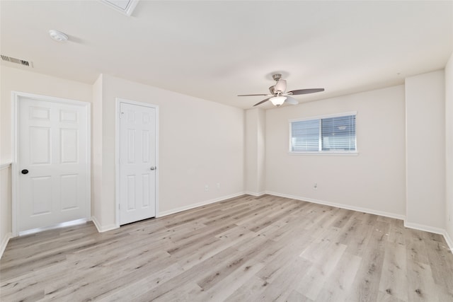 empty room with light hardwood / wood-style flooring and ceiling fan