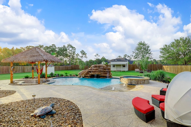 view of pool with pool water feature, an outdoor structure, an in ground hot tub, and a patio area