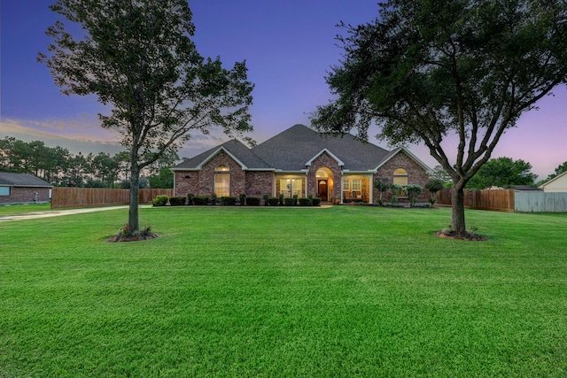 ranch-style home with a yard