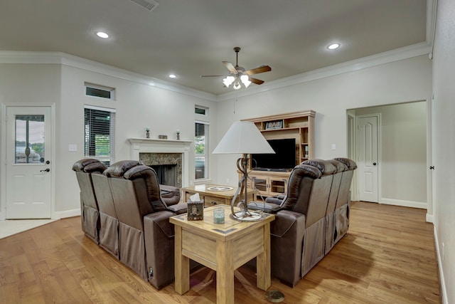 living room with ornamental molding, ceiling fan, and light hardwood / wood-style flooring