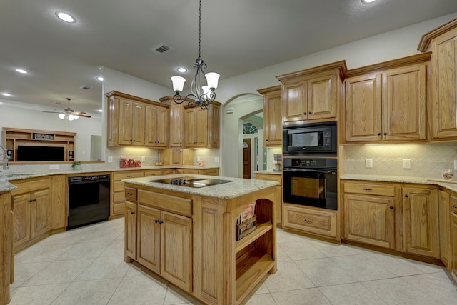 kitchen with black appliances, decorative light fixtures, a center island, and light tile patterned floors