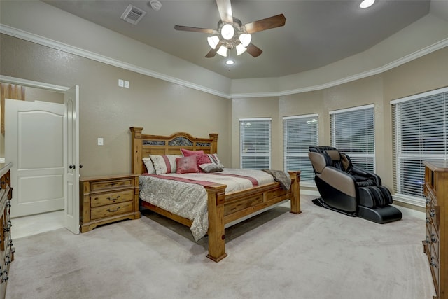 carpeted bedroom featuring ceiling fan, a tray ceiling, and ornamental molding