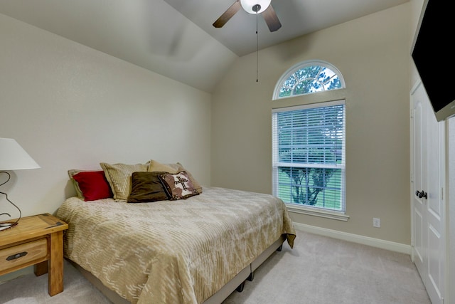 bedroom featuring ceiling fan, lofted ceiling, and light carpet