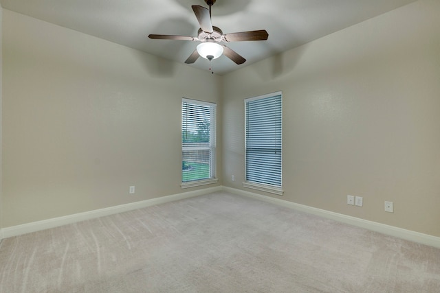 carpeted spare room with ceiling fan