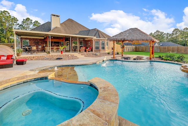 view of swimming pool featuring an in ground hot tub, a gazebo, and a patio area