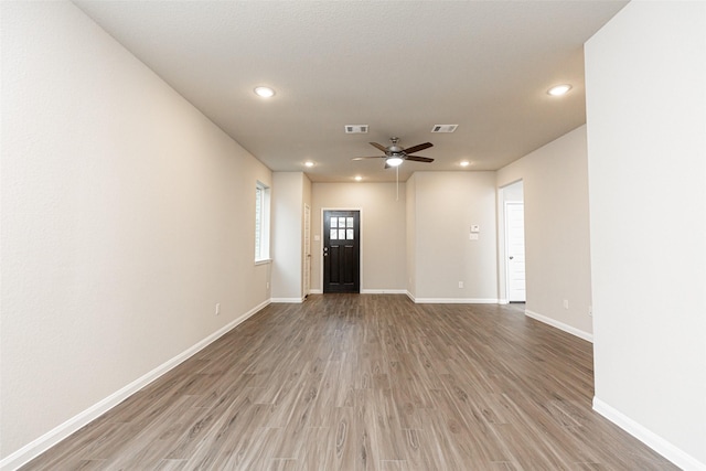 interior space featuring hardwood / wood-style floors and ceiling fan