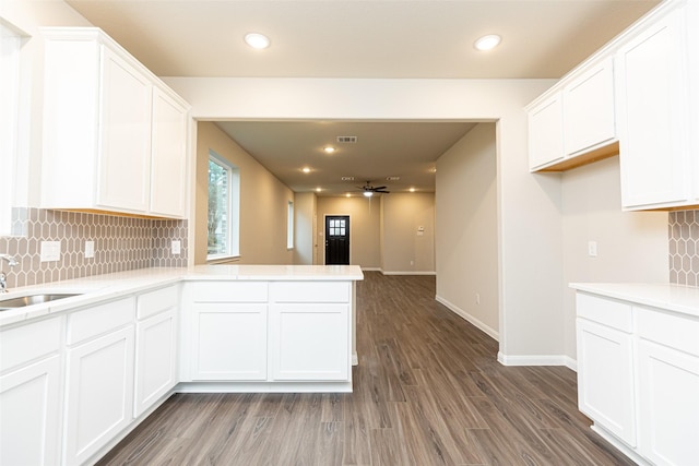 kitchen with dark hardwood / wood-style flooring, tasteful backsplash, ceiling fan, sink, and white cabinetry