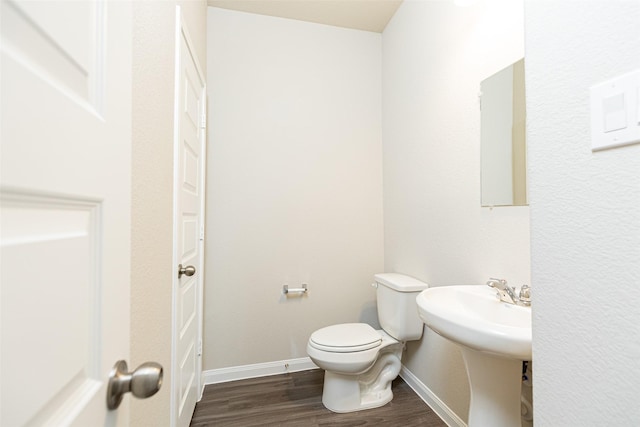 bathroom featuring hardwood / wood-style floors and toilet