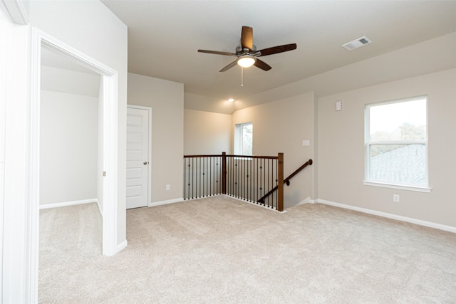 spare room featuring ceiling fan and light colored carpet