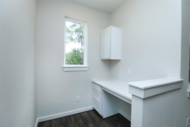 unfurnished office featuring dark hardwood / wood-style flooring