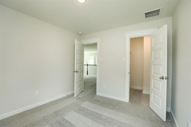 unfurnished bedroom with light colored carpet