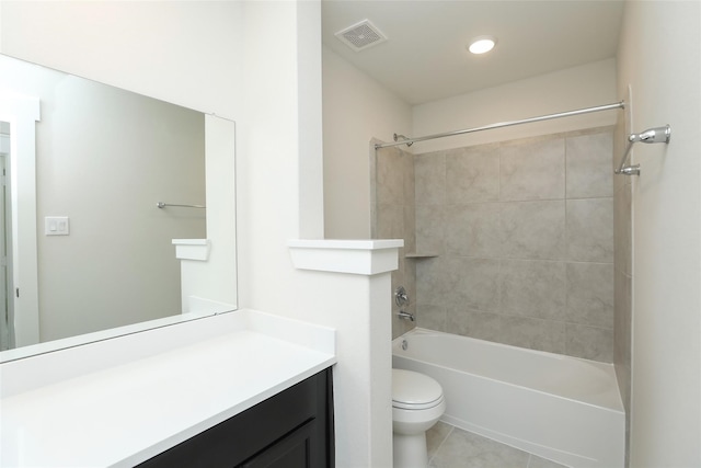 full bathroom with tiled shower / bath, vanity, toilet, and tile patterned floors