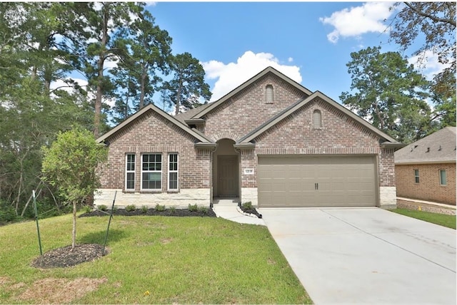 12135 Mustang Ave, Willis, TX 77378 - view of front of home with a garage, brick siding, concrete driveway, and a front yard