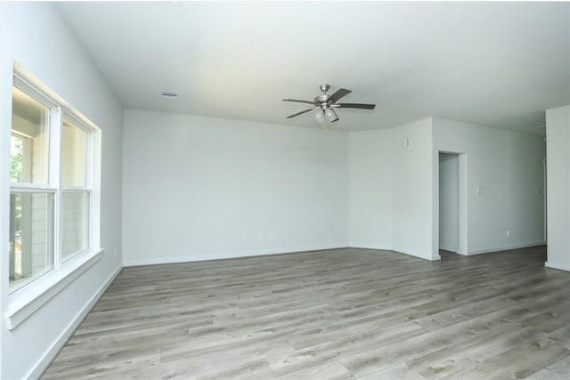 unfurnished room with ceiling fan and light hardwood / wood-style floors