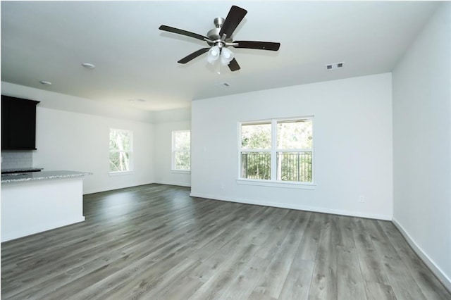 unfurnished living room featuring hardwood / wood-style floors and ceiling fan