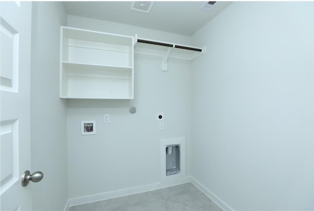 12135 Mustang Ave, Willis, TX 77378 - laundry area with hookup for a washing machine, hookup for an electric dryer, baseboards, and light tile patterned floors