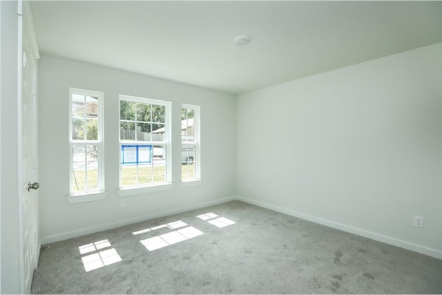 unfurnished room with light colored carpet