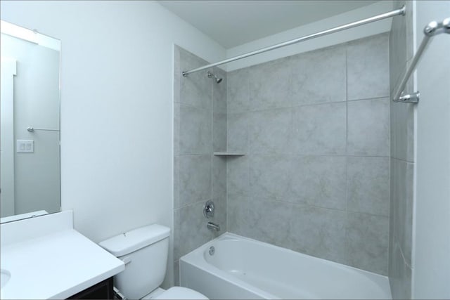 full bathroom featuring toilet, vanity, and tiled shower / bath