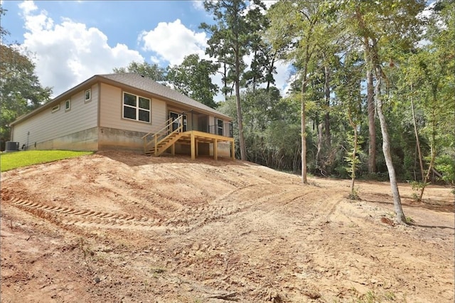12135 Mustang Ave, Willis, TX 77378 - rear view of house with stairs, cooling unit, and driveway