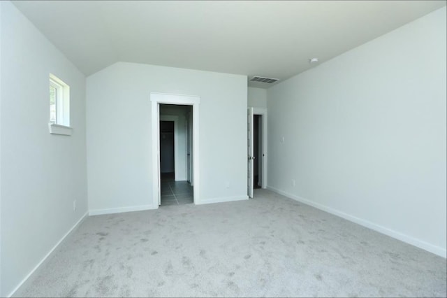 12135 Mustang Ave, Willis, TX 77378 - unfurnished bedroom featuring light carpet, baseboards, and lofted ceiling