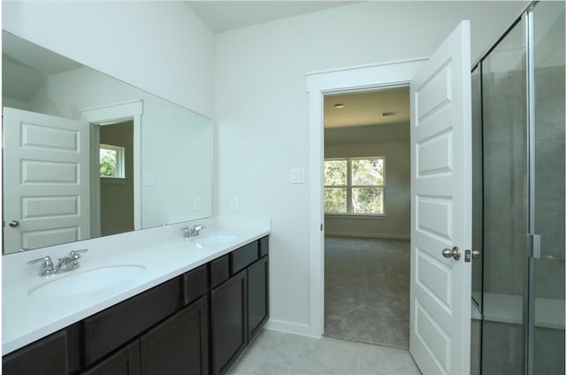 bathroom with vanity, a shower with door, and tile patterned floors