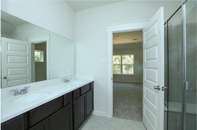 12135 Mustang Ave, Willis, TX 77378 - full bath with a shower stall, double vanity, baseboards, and tile patterned flooring