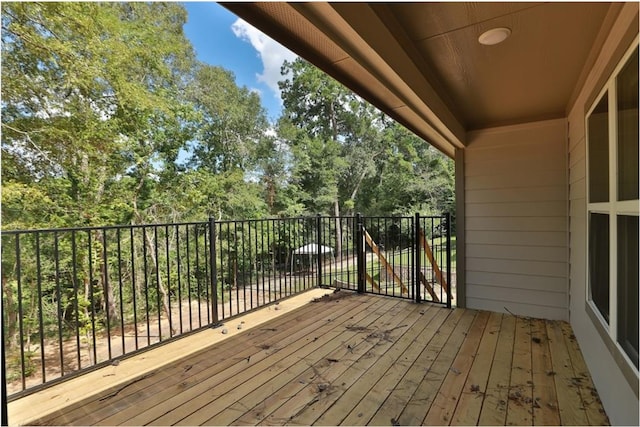 12135 Mustang Ave, Willis, TX 77378 - wooden deck featuring view of scattered trees