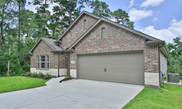 12135 Mustang Ave, Willis, TX 77378 - view of front of home with a garage, brick siding, concrete driveway, and a front yard