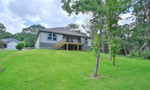 12135 Mustang Ave, Willis, TX 77378 - back of property featuring stairway, a deck, and a yard