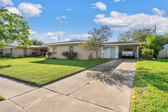 ranch-style house featuring a carport, a garage, and a front yard