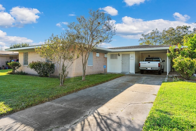 ranch-style house featuring a front lawn and a carport