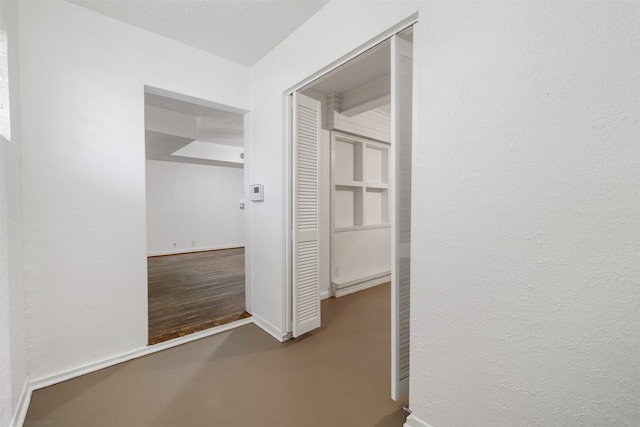 hallway with hardwood / wood-style floors