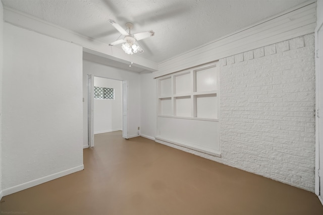 empty room with concrete flooring, a textured ceiling, and ceiling fan