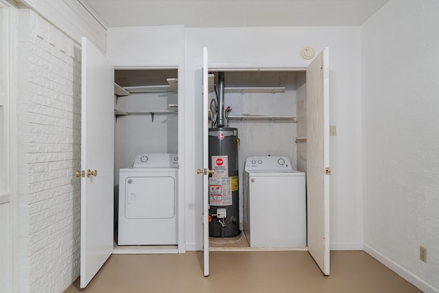 washroom with gas water heater and washer / dryer