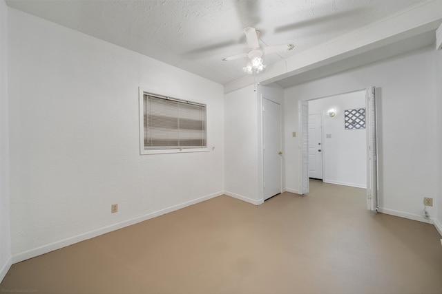 unfurnished room featuring ceiling fan and a textured ceiling