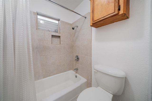 bathroom with shower / tub combo and toilet