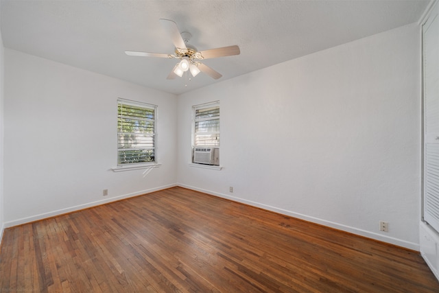 spare room featuring cooling unit, ceiling fan, and dark hardwood / wood-style floors